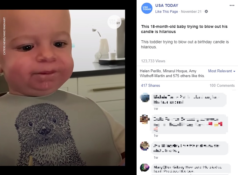 息が上手く吐けず顔を真っ赤にするテオ君（画像は『USA TODAY　2020年11月22日付Facebook「This 18-month-old baby trying to blow out his candle is hilarious」』のスクリーンショット）