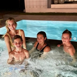 感謝祭に公開した、イヴァンカと3人の子どもたちの親子ショット。夜のプールに入りながら、カメラに向かって微笑んでいる（画像は『Ivanka Trump　2023年11月23日付Instagram「Night swim with these turkeys !」』のスクリーンショット）